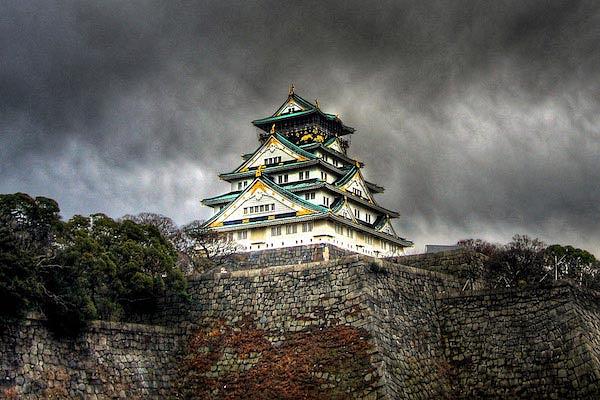 Imposing Osaka Castle with a stormy sky in the background